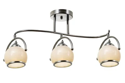 Chrome plated three-lamp ceiling lamp with matt white shades Stock Photos