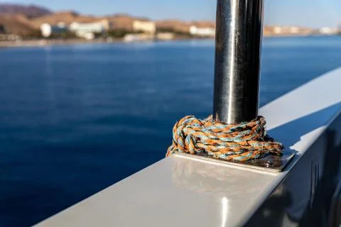 Chrome railing with a rope on a ship Stock Photos