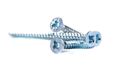Chrome screw on white background. Self-tapping screws from steel close-up Stock-Fotos