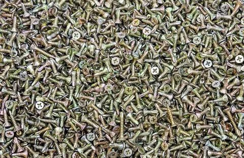 Chrome self-tapping screws on the counter of a hardware store. Stock Photos