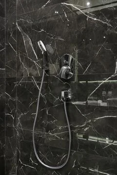 Chrome shower head on marble Stock Photos