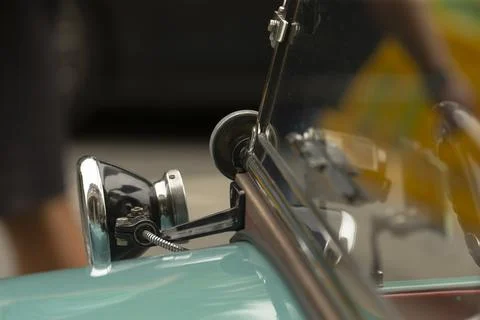 Chrome side mirror and windshield detail on vintage turquoise car Stock Photos