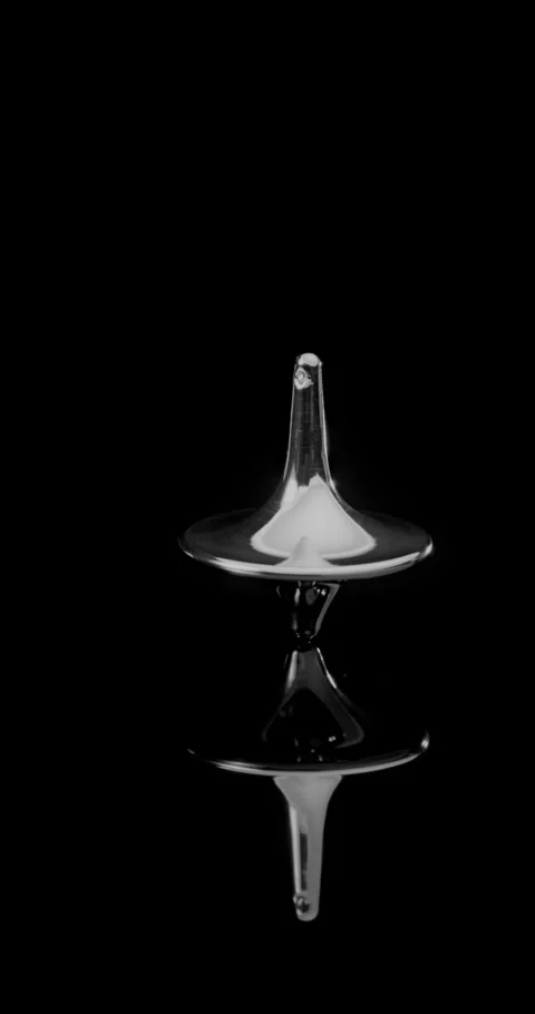 Chrome Spinning Top on Black Reflective Surface. Stock Footage 329605811