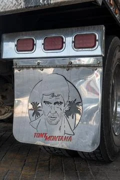 Chrome truck mud flap featuring Tony Montana portrait and palm trees in Stock Photos