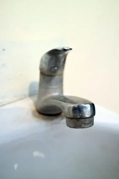 Chrome water shells over the sink Stock Photos