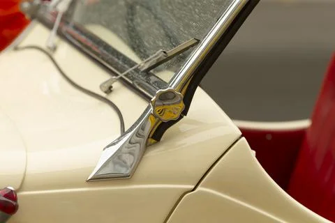 Chrome windshield hinge and cream car body detail Stock Photos