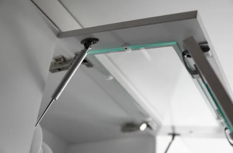 Chromic cabinet swing door hinge and door pump, build in furniture fittings Stock Photos