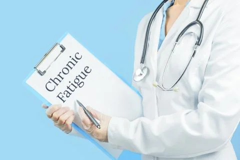 Chronic fatigue text on message pad. Female doctor Stock Photos