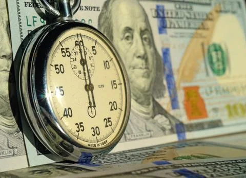 The Chronometer on the background of dollar bills (time - money, income, loan Stock Photos
