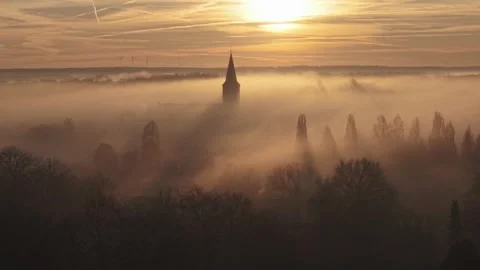 Chruch emerging from a mist covered landscape Stock Footage 303994370