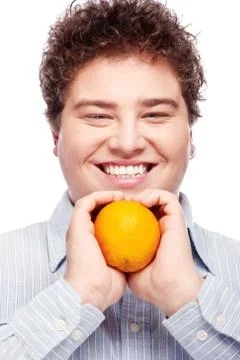 Chubby boy and orange Stock Photos