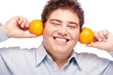 Chubby boy and orange Stock Photos