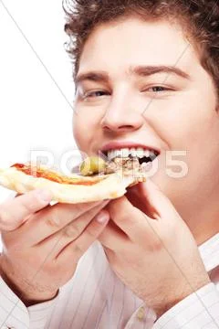 Chubby boy eating a slice of pizza Stock Photos