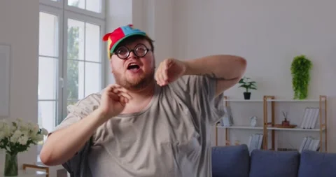 Chubby excited man dancing goofy at home, showing funny silly dance moves Stock Footage 325677238
