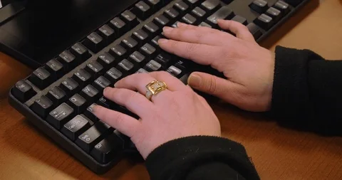 Chubby female typing on black computer keyboard at call center working on PC 4k Stock Footage 125110048