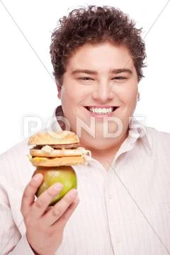 Chubby man holding apple and hamburger Stock Photos