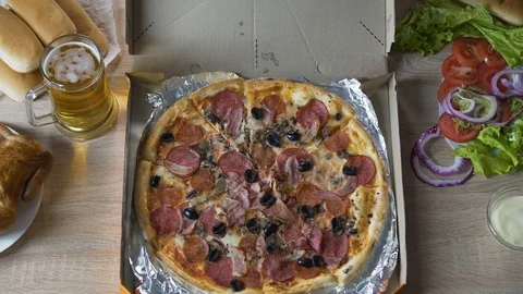 Chubby man sitting at table with harmful food and eating pizza with pleasure Video stock 81322628