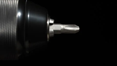 Chuck for cordless screwdriver with bit on black background, rotates, close up Stock Footage 306090791
