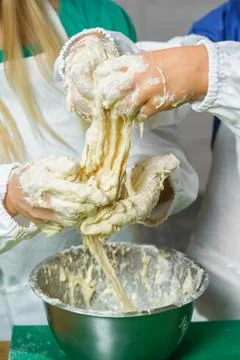 Chuldren hands kneading a dough Stock Photos