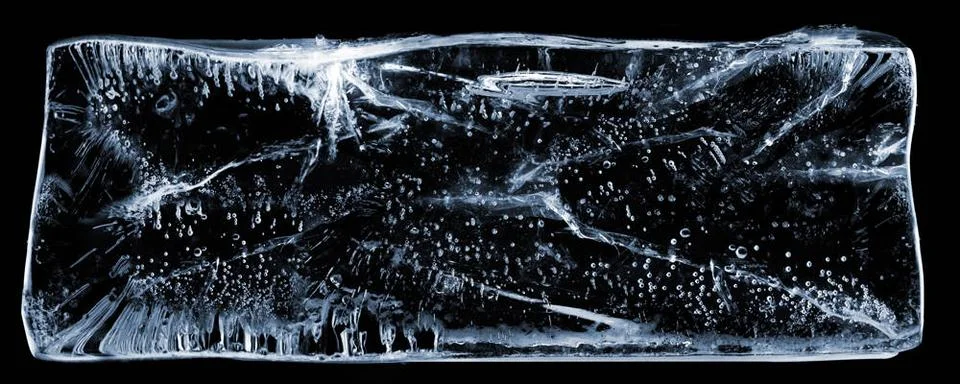 Chunk of Clear Ice. Large rectangle of clear ice with bubbles, on black. ,... Stock Photos