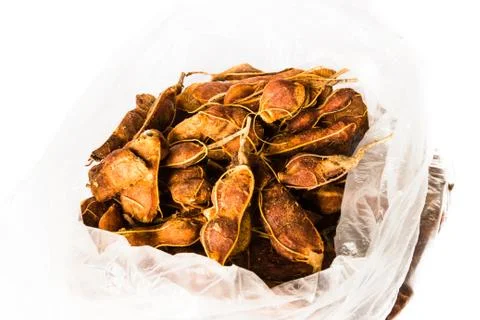 Chunk of fresh tamarind a white background in plastic bag. Foto stock