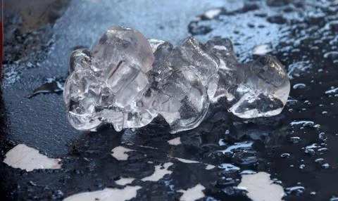 A chunk of melting ice on peeling table Stock Photos