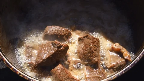 Chunks of beef are stewed in a cauldron Stock Footage 111135240
