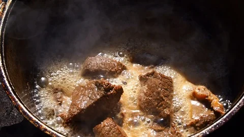 Chunks of beef are stewed in a cauldron Stock Footage 111135294