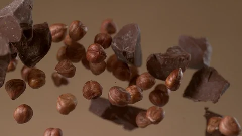 Chunks of chocolate and hazelnuts flying in slow motion.  Shot with Phantom Flex Stock Footage 130356348