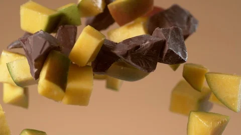 Chunks of chocolate and mango flying in slow motion.  Shot with Phantom Flex 4K Stock Footage 130355955