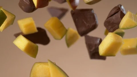 Chunks of chocolate and mango flying in slow motion.  Shot with Phantom Flex 4K Stock Footage 130355969
