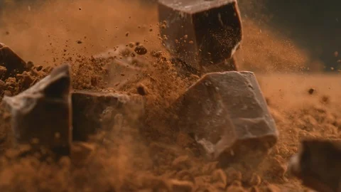 Chunks of chocolate falling into powdered chocolate, shot with Phantom Flex 4K Stock Footage 101034554
