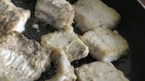 Chunks of cod fish are fried in a pan. healthy food concept Video stock 154620979