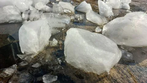 Chunks of crystal ice melt in hot weather. Stock Photos