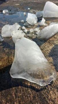 Chunks of crystal ice melt in hot weather. Stock Photos