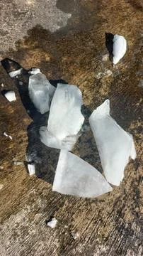 Chunks of crystal ice melt in hot weather. Stock Photos