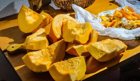 Chunks, cut a large pumpkin on the table. Stock Photos