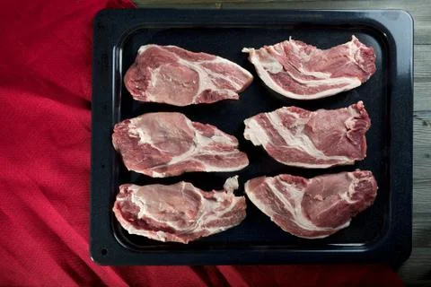 Chunks of fresh pork meat on a baking sheet Stock Photos