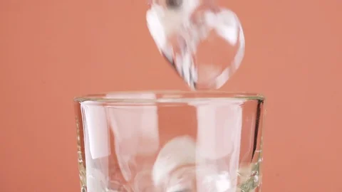 Chunks of ice in a glass close up Video stock 128546594