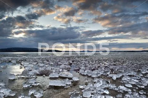 Chunks of ice lying on icy surface on the shore of reichenau island, baden-wu Stock Photos