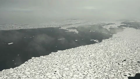Chunks of ice on the water. Aerial view. Lots of broken ice. Low cloud. The ice Stock Footage 144657669