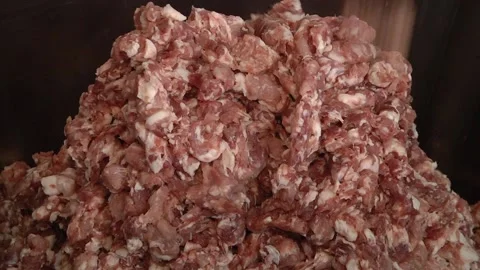 Chunks of meat in an industrial meat grinder. Stock Footage 99490322