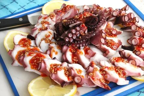 Chunks of octopus on a cutting Board Stock Photos