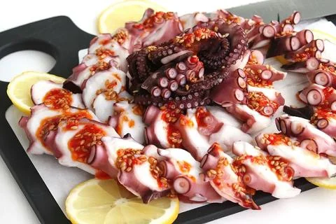 Chunks of octopus on a cutting Board Stock Photos