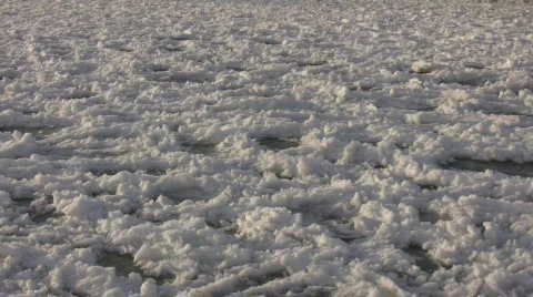 Chunks of snowy ice gently bob on water (High Definition) Stock Footage 64376