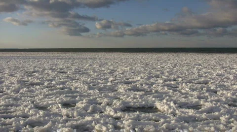 Chunks of snowy ice gently bob on water (High Definition) Stock Footage