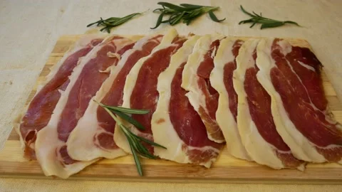 Chunks of thinly sliced jerky on a wooden board Stock Footage 161664943