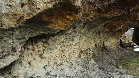 Chunks of yellowish-gray rock with a blurry sky background Stock Footage 239702995