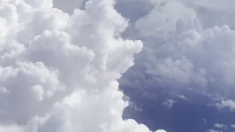 Chunky white clouds as seen from a plane's window Stock Footage 232341611