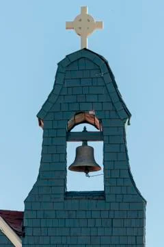 Church bell in a tower under a cloudless sky Stock Photos